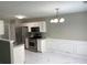 Bright eat-in kitchen with white cabinets and stainless steel appliances at 646 Lakes Cir, Lithonia, GA 30058