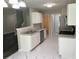 Spacious kitchen featuring stainless steel appliances, tiled floors, and modern white cabinetry at 646 Lakes Cir, Lithonia, GA 30058