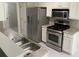 Well-lit kitchen featuring stainless steel appliances and stylish countertops at 646 Lakes Cir, Lithonia, GA 30058