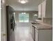 Bright eat-in kitchen with stainless steel appliances, white cabinets, and modern light-colored flooring at 646 Lakes Cir, Lithonia, GA 30058