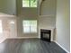 Living room featuring a cozy fireplace, high ceilings, and plenty of natural light at 646 Lakes Cir, Lithonia, GA 30058