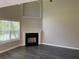 Bright living room with fireplace, large windows, and neutral color palette at 646 Lakes Cir, Lithonia, GA 30058