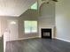 Open living room with soaring ceilings, modern flooring, lots of natural light, and marble fireplace at 646 Lakes Cir, Lithonia, GA 30058