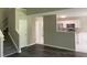 Open-concept design featuring modern flooring connecting living room, kitchen, and staircase at 646 Lakes Cir, Lithonia, GA 30058