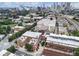Expansive aerial shot of neighborhood showing red brick buildings, trees, a self-storage unit, and the downtown skyline at 322 Peters Sw St # 2, Atlanta, GA 30313