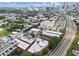Wide aerial view of the neighborhood with rooftops, trees, nearby train tracks, and the city skyline in the distance at 322 Peters Sw St # 2, Atlanta, GA 30313