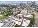 An aerial view capturing the blend of residential buildings, trees, and downtown buildings under a bright, sunny sky at 322 Peters Sw St # 2, Atlanta, GA 30313