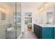 Modern bathroom features double vanity, glass shower with bench, neutral tile and views of the loft bedroom at 322 Peters Sw St # 2, Atlanta, GA 30313