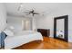 Loft bedroom featuring hardwood floors, ceiling fan, and walk-in glass shower at 322 Peters Sw St # 2, Atlanta, GA 30313