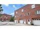 Brick building featuring ground-level garages and direct access doors, under a partly cloudy sky at 322 Peters Sw St # 2, Atlanta, GA 30313