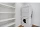 White laundry features a stacked washer and dryer with built-in shelves for added convenience at 322 Peters Sw St # 2, Atlanta, GA 30313