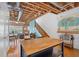 Open living room showcasing the dining area, stairs to 2nd floor, exposed ceiling, and wood floors at 322 Peters Sw St # 2, Atlanta, GA 30313
