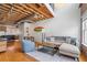 Open-concept area with hardwood floors, exposed ceilings, and a comfortable seating arrangement at 322 Peters Sw St # 2, Atlanta, GA 30313