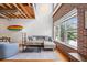 Inviting living space featuring exposed wood ceilings, a gray sofa, and natural light at 322 Peters Sw St # 2, Atlanta, GA 30313