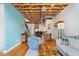 Stylish living area with an exposed ceiling, a vibrant accent wall, and hardwood floors at 322 Peters Sw St # 2, Atlanta, GA 30313