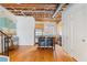 Open layout featuring hardwood floors, exposed ceiling, stairs, and stainless steel kitchen appliances at 322 Peters Sw St # 2, Atlanta, GA 30313