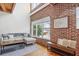 Modern living room featuring a brick accent wall, large windows, and hardwood floors at 322 Peters Sw St # 2, Atlanta, GA 30313