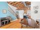 Open living room with exposed ceiling beams, hardwood floors, and a dining table at 322 Peters Sw St # 2, Atlanta, GA 30313
