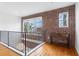 Loft area showcasing brick walls, hardwood floors, and natural light streaming through the windows at 322 Peters Sw St # 2, Atlanta, GA 30313