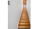 Wooden staircase leads to the upper levels with a modern railing and white wall at 322 Peters Sw St # 2, Atlanta, GA 30313