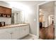 Bright bathroom with a tiled countertop, white cabinets and a view of the hallway at 4882 Rabbit Farm Road Rd, Loganville, GA 30052