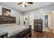 Charming bedroom with hardwood floors, a ceiling fan, and a rustic wood bed frame at 4882 Rabbit Farm Road Rd, Loganville, GA 30052