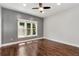 Bright bedroom featuring a ceiling fan, hardwood floors, and a large window with natural light at 4882 Rabbit Farm Road Rd, Loganville, GA 30052