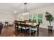 Open and airy dining room featuring hardwood floors, an elegant light fixture and a large window at 4882 Rabbit Farm Road Rd, Loganville, GA 30052