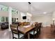 Open-concept space with hardwood floors, a dining table set for six and large windows throughout at 4882 Rabbit Farm Road Rd, Loganville, GA 30052