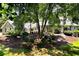 Inviting gray two-story home featuring manicured lawn, mature trees, and tasteful landscaping at 4882 Rabbit Farm Road Rd, Loganville, GA 30052