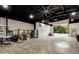 Large garage with an open door, equipped with tools and storage for versatile use at 4882 Rabbit Farm Road Rd, Loganville, GA 30052