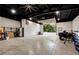 Spacious garage with concrete floors, metal walls, and an open overhead door at 4882 Rabbit Farm Road Rd, Loganville, GA 30052