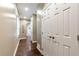 Long hallway with wood floors, neutral paint, and multiple storage closets at 4882 Rabbit Farm Road Rd, Loganville, GA 30052