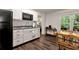 Cozy kitchen with modern appliances, white cabinets, and eat-in dining area at 4882 Rabbit Farm Road Rd, Loganville, GA 30052