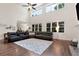 Bright living room with high ceilings, a ceiling fan, hardwood floors, and a large leather sectional sofa at 4882 Rabbit Farm Road Rd, Loganville, GA 30052