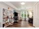 Inviting Gathering room with a wall of built-in shelving, dark wood floors and a view of the yard at 4882 Rabbit Farm Road Rd, Loganville, GA 30052