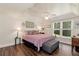 Inviting main bedroom with natural light, wood floors, and a ceiling fan at 4882 Rabbit Farm Road Rd, Loganville, GA 30052