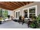 Charming covered patio with seating, wood ceiling, and view of the surrounding lush landscape at 4882 Rabbit Farm Road Rd, Loganville, GA 30052