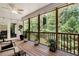 Covered porch with outdoor seating, ceiling fan, and view of the wooded backyard at 4882 Rabbit Farm Road Rd, Loganville, GA 30052