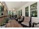 Covered porch with outdoor seating, ceiling fan, and peaceful wooded view at 4882 Rabbit Farm Road Rd, Loganville, GA 30052