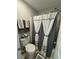Bathroom with a toilet, shower, and decorative shower curtains at 6432 Polar Fox Ct, Riverdale, GA 30296