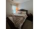 Bedroom with a large bed with lots of pillows and an elegant bed frame at 6432 Polar Fox Ct, Riverdale, GA 30296