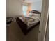 Bedroom with a large bed with lots of pillows and an elegant bed frame at 6432 Polar Fox Ct, Riverdale, GA 30296