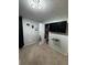Bedroom with a wall-mounted TV and open closet offering storage solutions at 6432 Polar Fox Ct, Riverdale, GA 30296
