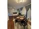 A cozy dining area with hardwood floors and grey curtains, connected to the living room at 6432 Polar Fox Ct, Riverdale, GA 30296