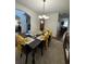 Bright dining room with a large table set for a meal, complemented by hardwood floors and natural light at 6432 Polar Fox Ct, Riverdale, GA 30296