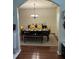 Elegant dining room with hardwood floors, decorative lighting, and ample space for entertaining guests at 6432 Polar Fox Ct, Riverdale, GA 30296
