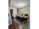 Well-lit dining room featuring a dining table with seating, hardwood floors, and classic decor at 6432 Polar Fox Ct, Riverdale, GA 30296