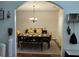 Elegant dining room featuring hardwood floors, a chandelier, and a beautifully set table for formal dining at 6432 Polar Fox Ct, Riverdale, GA 30296
