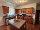 Kitchen featuring wooden cabinets, stainless steel appliances, and an island for food preparation at 6432 Polar Fox Ct, Riverdale, GA 30296